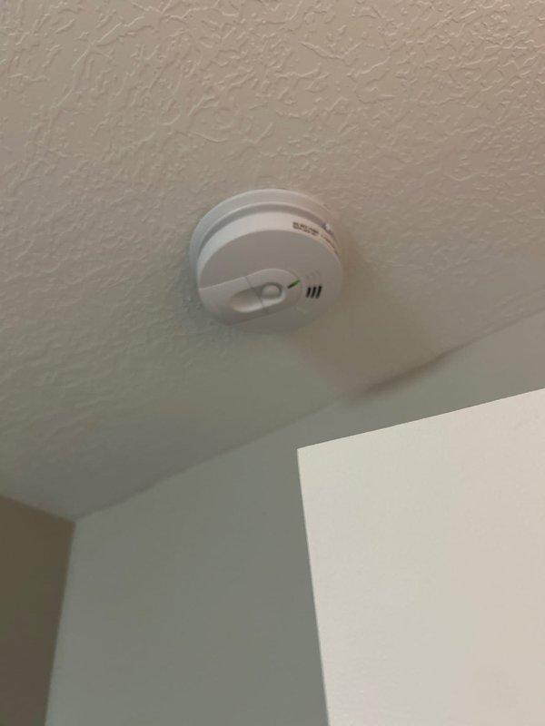 Completed routine electrical maintenance inspection for Green Shield member at residential property. Verified operation and functionality of smoke detector mounted on ceiling, confirming proper installation and indicator light operation. Inspected and tested GFCI outlet with reset/test button functionality, verified proper grounding and protection. Examined electrical conduit routing and connections, ensuring secure mounting and proper termination at junction points. All components found to be functioning within normal parameters with no immediate safety concerns identified.