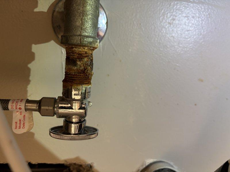 Responded to service call for leaking kitchen faucet with leaks occurring both under the sink at the supply connections and at the nozzle assembly. Upon arrival, inspected 11-year-old deck-mounted kitchen faucet and identified worn internal components and deteriorated seals as source of leakage. Assessed water supply lines and shut-off valves serving the fixture, noting corrosion on existing pipe threading and connections. Verified water pressure at supply lines using pressure gauge to ensure proper operating conditions for replacement fixture. Evaluated condition of angle stop valves and supply connections, documenting significant mineral buildup and corrosion on older pipe sections while confirming functionality of chrome-plated shut-off valve. Due to age of existing faucet and extent of component wear, recommended full fixture replacement rather than repair. Proceeded with removal of failed faucet assembly and installation of new kitchen faucet unit. Secured new fixture to sink deck