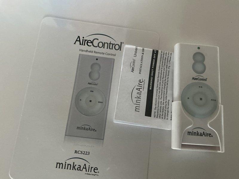 Responded to service call for two ceiling fans in vaulted ceiling area with one fan inoperative and the other experiencing receiver issues. Diagnosed non-functioning fan and determined receiver replacement necessary. Installed new AireControl RCS223 handheld remote control system with compatible receiver to restore proper fan operation and provide reliable wireless control functionality.