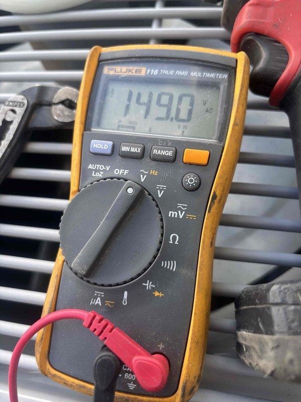 Responded to no cooling complaint on 7-year-old single-zone system with outdoor condensing unit and basement air handler. Upon arrival, performed diagnostic testing using multimeter to verify incoming line voltage at 149VAC and measured system pressures with manifold gauges. Identified cooling system deficiency and documented equipment conditions with photographs for service records.