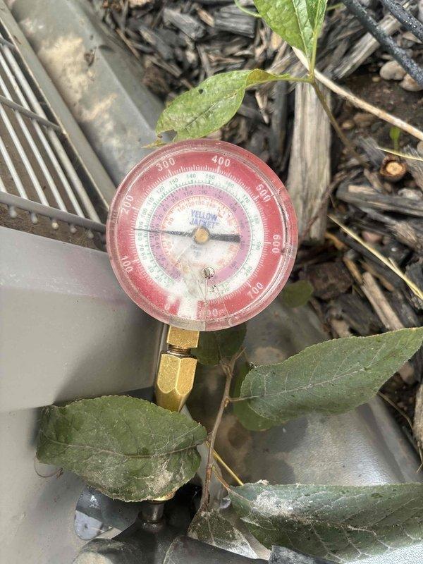 Responded to no cooling complaint on 7-year-old single-zone system with outdoor condensing unit and basement air handler. Upon arrival, performed diagnostic testing using multimeter to verify incoming line voltage at 149VAC and measured system pressures with manifold gauges. Identified cooling system deficiency and documented equipment conditions with photographs for service records.