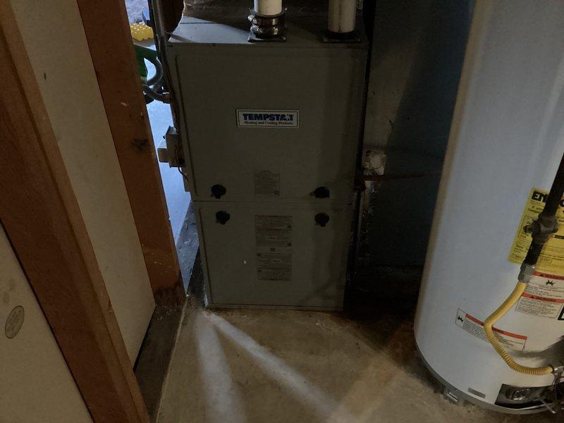 Responded to service call for potential refrigerant loss and suspected fan motor failure on 10+ year old single-zone cooling system. Performed comprehensive diagnostic evaluation of Tempstar furnace located in basement and outdoor condensing unit in backyard. Inspected condenser fan assembly through protective grille, observing normal surface weathering and minor dust accumulation on blades with no visible mechanical damage or obstruction. Evaluated refrigerant levels, electrical components, and overall system operation to determine root cause of cooling deficiency and verify fan motor functionality.