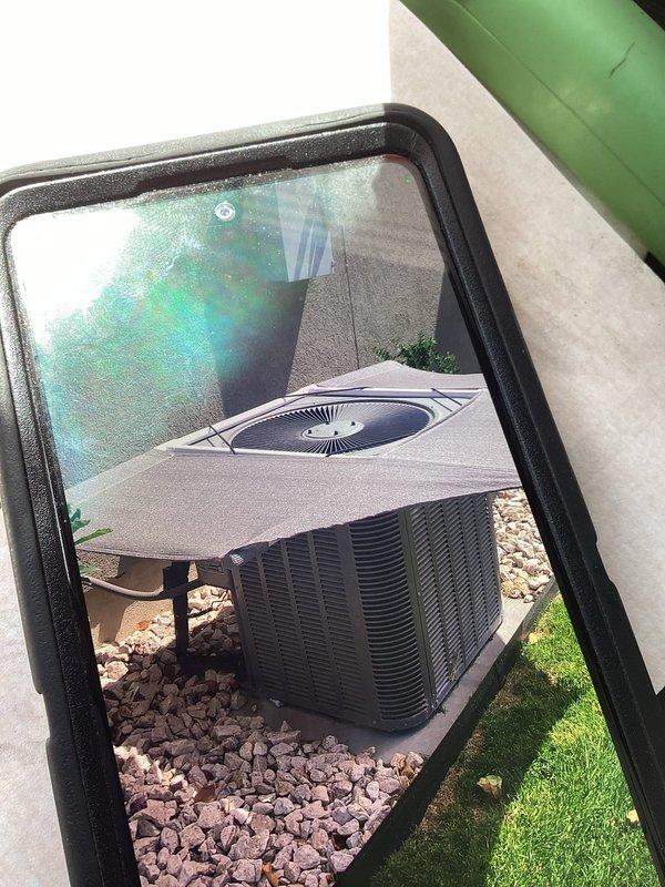 Completed comprehensive air conditioning tune-up and preventative maintenance inspection for residential split system. Performed visual inspection of outdoor condensing unit including heat pump with oval fan grille and cylindrical condenser coil. Inspected electrical control panel, verified capacitor connections and integrity, checked contactor operation, and examined all wire terminations for proper connection and no signs of overheating. Verified system mounted on decorative rock base with adequate clearance for airflow. All components operating within normal parameters upon completion of maintenance service.