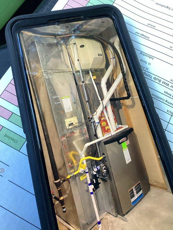 Completed annual cooling maintenance on two HVAC systems as part of membership plan. Performed comprehensive tune-up on both outdoor condensing units and indoor air handlers. Tested and measured capacitor performance using digital multimeter, verifying MARS 35x5.0 μF dual-run capacitor operating within specifications at 440VAC. Recorded amperage draw of 3.133 amps on compressor circuit, confirming normal operating parameters. Inspected condenser coils for cleanliness and airflow restrictions, noting minor dust accumulation with normal coloration. Verified refrigerant line insulation integrity on copper lines. Accessed basement mechanical room to inspect furnace and air handler components. Checked all electrical connections, contactors, and safety controls on both systems. Verified proper drainage from condensate lines and inspected PVC piping for blockages. Provided guidance on energy-saving practices regarding nighttime thermostat setback versus opening windows and shutting off AC sys