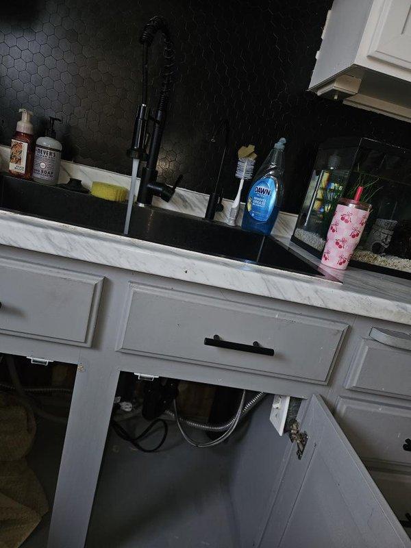 Responded to rental property for plumbing inspection to investigate known leak. Inspected bathroom vanity plumbing connections including flexible supply lines beneath sink cabinet. Documented conditions and photographed affected areas for property owner records.