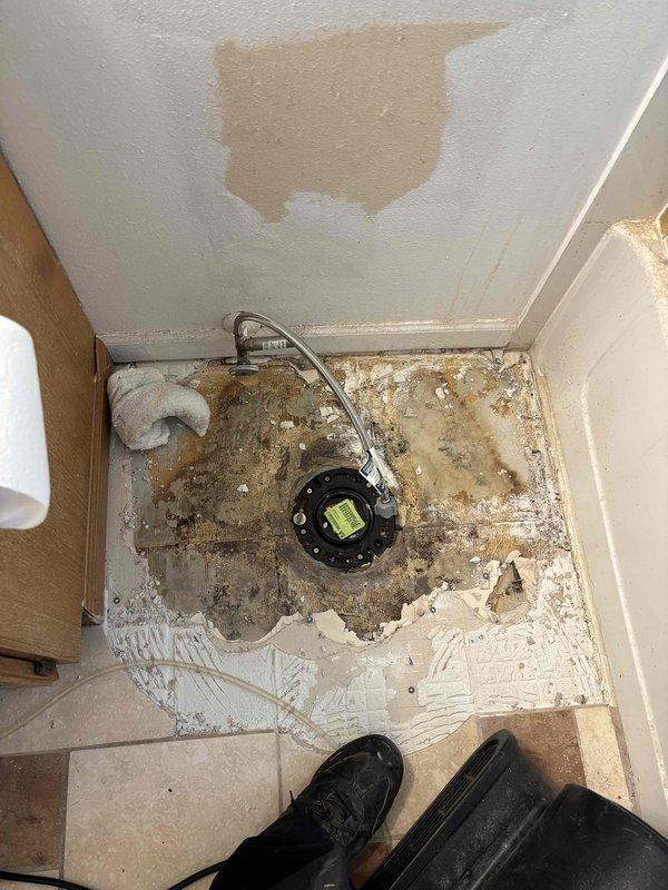Jackhammered and removed concrete and decorative tile flooring to expose the closet 90 drain fitting. Installed new toilet flange with proper mounting and sealing. Re-poured concrete underlayment in the excavated area to restore proper floor elevation. Cut out existing 3-inch ABS 90 degree elbow and flange assembly. Reset toilet on new flange and performed leak testing to verify proper seal and drainage. Installed new emergency shutoff valve for toilet water supply line. Vanity disconnection was performed as needed to facilitate access to plumbing connections. Drywall remained open for inspection and final finishing work. Tile replacement was not included in scope of work.