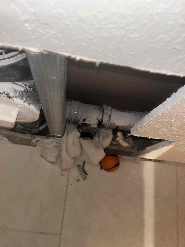 Responded to service call for damaged ABS cleanout tees near the sewer main resulting from previous contractor work where drywall installer had drilled through one cleanout plug. Assessed compromised plumbing system following major flood and remodel, determining that limited access and floor proximity required complete rebuild of affected drain sections. Relocated appliances to gain proper access to work area. Acquired specialized tools and utilized onboard materials to replace two broken and crunched ABS cleanout tees. Reconstructed plumbing assembly to code specifications, ensuring proper cleanout access and system integrity. Verified all connections were secure and leak-free upon completion.