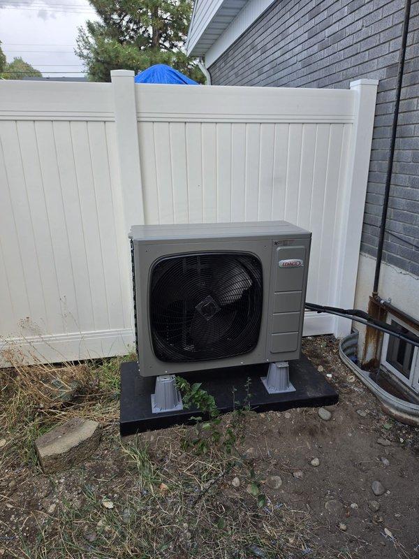 Completed full HVAC system replacement in basement, installing Lennox ML15KSPV-030-230 outdoor condensing unit and CK40CT-30/36A-71 air handler. Reused existing lineset after performing thorough flush to ensure system cleanliness and proper refrigerant flow. Retained existing thermostat per customer request. Mounted outdoor unit on composite pad in side yard area against building exterior with proper clearances from fencing and foundation. Connected refrigerant lines and electrical service, tested system operation, and verified proper airflow and temperature differential. System commissioned successfully and left in full operational status.