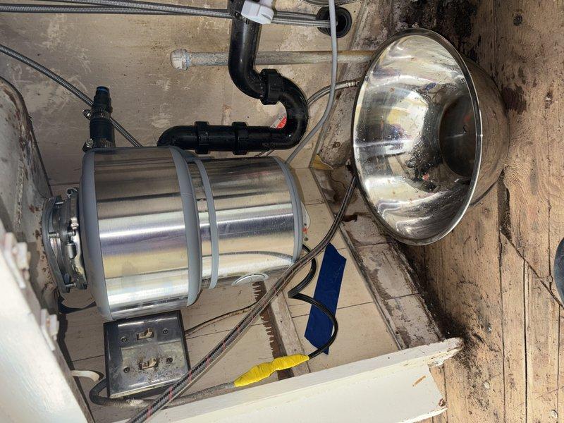 Completed callback service to address incomplete work from previous visit. Kitchen sink disposal was not properly connected to drain system during initial service call, resulting in water leaking onto floor when sink was in use. Successfully installed and connected disposal unit to existing drain plumbing, tested system for proper drainage and verified no leaks present at connections or trap assembly.