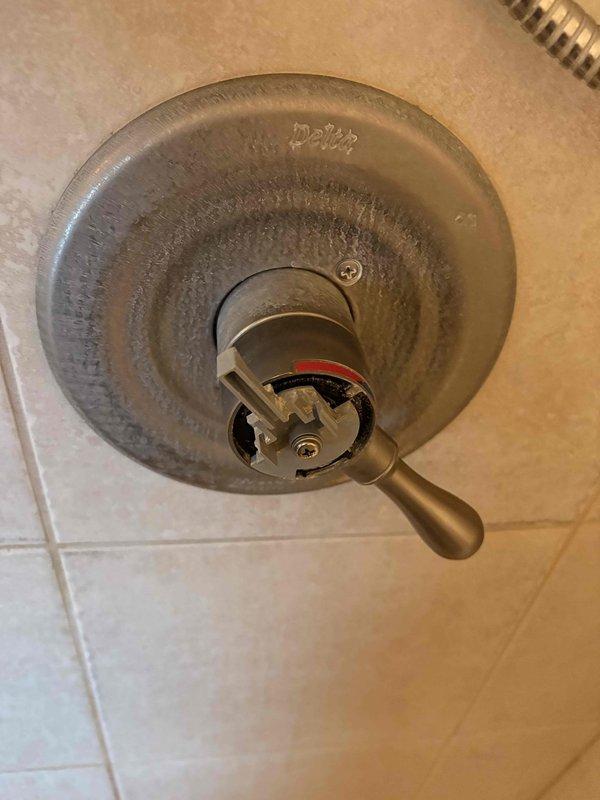 Responded to a known leak originating from kitchen sink plumbing that caused water damage in the basement furnace room. Inspected broken pipe in furnace room area and assessed 1990-91 era plumbing system. Additionally evaluated minor intermittent leak at bathroom sink fixture showing hard water mineral buildup and staining on shower valve escutcheon. Documented system pressure readings and overall plumbing conditions in mechanical room area.
