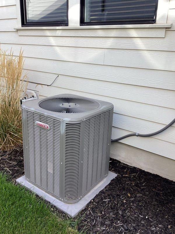 Completed membership maintenance on Lennox air conditioning system located on west side of residence. Performed comprehensive tune-up including visual inspection of condenser unit, verified proper clearances and mounting, and conducted electrical diagnostics using Fieldpiece SC440 meter to measure voltage and amperage at compressor terminals. Unit operating within normal parameters with readings at 10.55 volts displayed during testing. Exterior components in good condition with no visible damage or excessive wear noted.