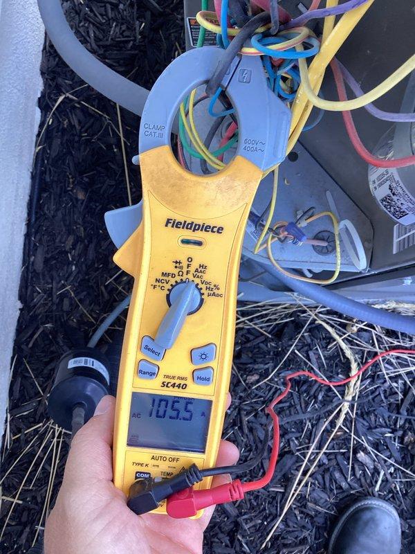 Completed membership maintenance on Lennox air conditioning system located on west side of residence. Performed comprehensive tune-up including visual inspection of condenser unit, verified proper clearances and mounting, and conducted electrical diagnostics using Fieldpiece SC440 meter to measure voltage and amperage at compressor terminals. Unit operating within normal parameters with readings at 10.55 volts displayed during testing. Exterior components in good condition with no visible damage or excessive wear noted.