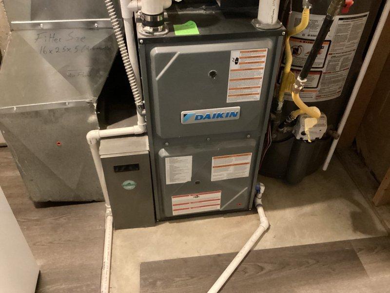 Responded to service call for AC system reported as not turning on. Upon arrival, performed diagnostic evaluation of 6-year-old Daikin HVAC system with outdoor unit located on north side and furnace/air handler in basement. Inspected air handler cabinet, condensate drain lines, refrigerant lines, electrical connections, and all associated components. Verified system operation and determined that intermittent issue had self-resolved prior to arrival. System found operating within normal parameters at time of inspection with no active faults present.