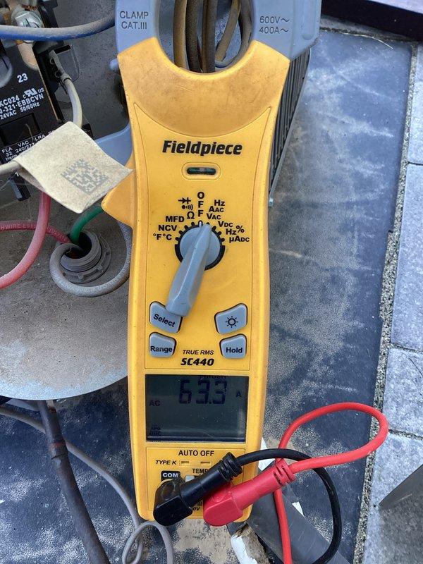 Completed routine membership maintenance inspection on two 6-year-old air conditioning systems with condensers located on back side of property and air handlers in basement and upstairs locations. Performed comprehensive system evaluation including refrigerant line inspection, capacitor testing showing 63.3 MFD reading, and filter-drier component assessment. Noted oxidation and discoloration on copper refrigerant lines with existing foam insulation wrap. Both systems operational with no reported issues at time of service.