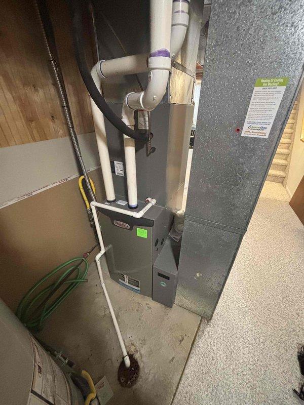 Completed comprehensive furnace maintenance on 12-year-old Lennox CB29-42B-0F-2 unit located in basement. Performed full system inspection including heat exchanger examination, burner assembly cleaning, and flame sensor maintenance. Verified proper gas pressure and combustion efficiency. Inspected and tested all safety controls including limit switches and rollout sensors. Checked blower motor operation and lubricated as needed. Replaced air filter and cleaned blower compartment. Tested thermostat operation and verified proper system cycling. Inspected condensate drain system and PVC venting for proper operation and secure connections. Confirmed R-410A refrigerant specifications on unit nameplate. All components operating within manufacturer specifications. System ready for heating season.