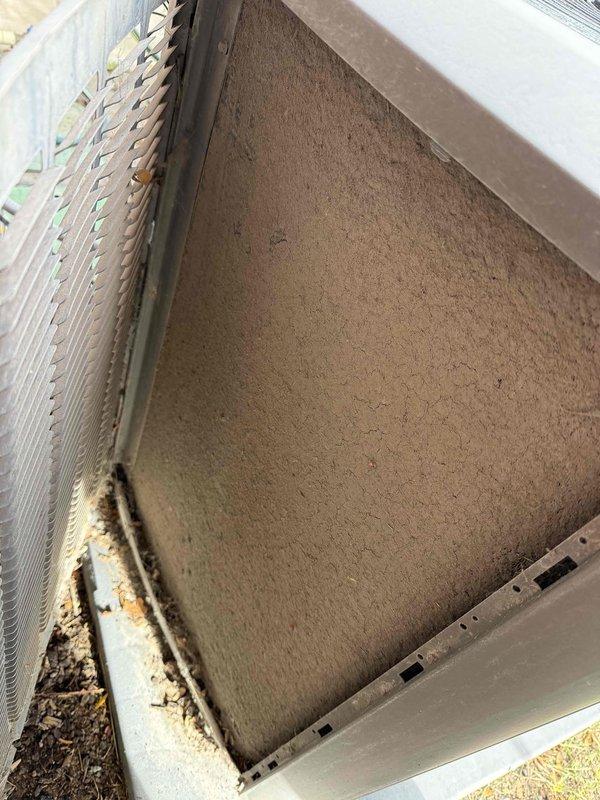 Completed Gold-level heating and cooling maintenance on 8-year-old residential HVAC system consisting of one furnace and one air conditioning unit. Performed comprehensive inspection of both systems, including filter examination which revealed heavy dust and debris accumulation requiring attention. Inspected dual-run capacitor rated at 40+10 MFD, 370 VAC, manufactured in October 2021, confirmed proper operation within specifications. Noted visible deterioration and rust staining on lower filter frame assembly with accumulated grime present. Observed wear patterns on air handler housing and surrounding components consistent with system age. Checked all accessible mechanical and electrical components per Gold maintenance protocol standards, ensuring proper system operation for both heating and cooling functions.