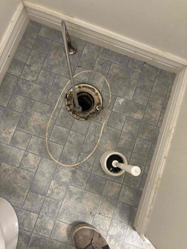 Responded to service call for clogged toilet and shower drains in residential bathroom. Upon arrival, inspected bathroom fixtures and drainage system. Located floor drain with visible corrosion and buildup around drain flange. Cleared obstruction from toilet drain line and shower drain to restore proper drainage and flow. Verified both fixtures were draining properly upon completion of service.