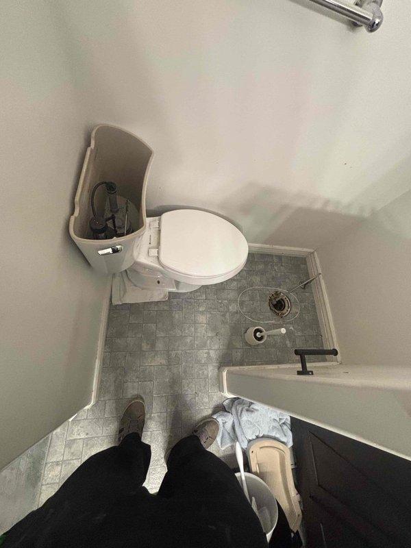 Responded to service call for clogged toilet and shower drains in residential bathroom. Upon arrival, inspected bathroom fixtures and drainage system. Located floor drain with visible corrosion and buildup around drain flange. Cleared obstruction from toilet drain line and shower drain to restore proper drainage and flow. Verified both fixtures were draining properly upon completion of service.