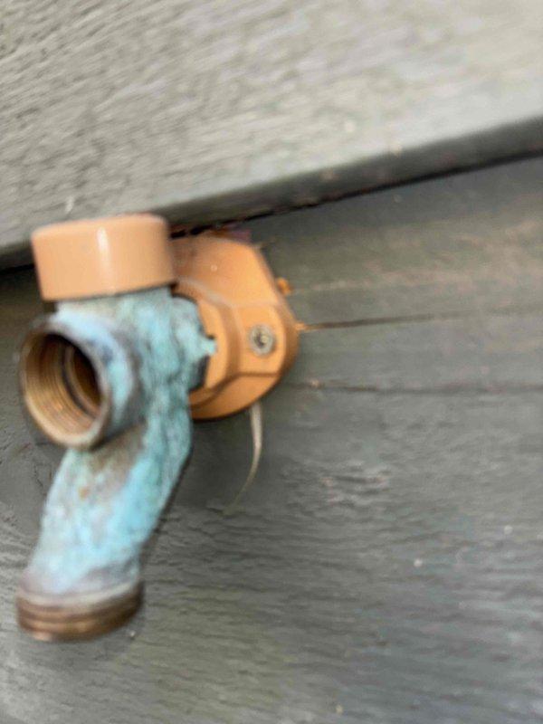 Responded to service call for outdoor hose bib that was spinning and not catching properly. Upon inspection, found exterior faucet with corroded brass/copper threading and worn valve seat preventing proper engagement. The fixture displayed significant oxidation and blue-green patina consistent with extended weather exposure. Removed failed hose bib assembly from exterior wall mounting, cleared corroded threads, and installed new frost-proof sillcock with brass construction and updated valve mechanism. Verified proper water flow, tested valve operation through full range of motion, and confirmed secure mounting to prevent spinning. System returned to full operational status with no leaks detected.