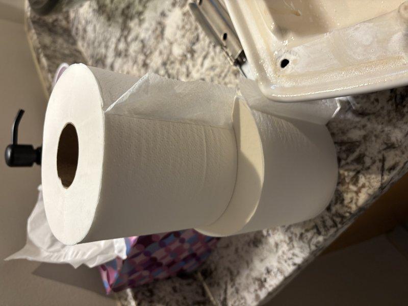 Responded to emergency call for active leak originating from master bathroom with water penetrating to lower level. Inspected bathroom fixtures, water supply lines, and surrounding areas to identify source of leak. Located issue at toilet water supply connection where braided supply line showed signs of failure at wall mounting point, causing water to seep through flooring and ceiling below.