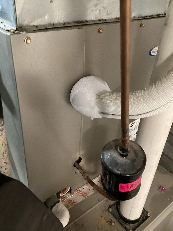 Responded to callback for AC system that had been freezing up repeatedly over multiple days. Upon inspection, found evaporator coil frozen solid due to restricted refrigerant flow. Installed new filter-drier on copper refrigerant line to remove moisture and contaminants from system. Verified thermostat operation showing 79°F indoor temperature and proper communication with air handler. Allowed system to thaw completely before restarting, confirmed proper airflow through evaporator coil, and monitored system operation to ensure no further freeze-up conditions.
