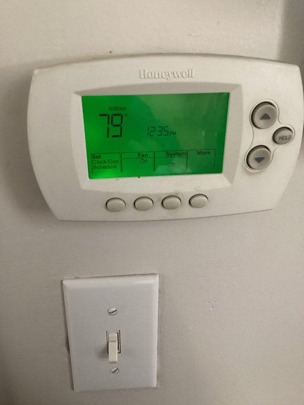Responded to callback for AC system that had been freezing up repeatedly over multiple days. Upon inspection, found evaporator coil frozen solid due to restricted refrigerant flow. Installed new filter-drier on copper refrigerant line to remove moisture and contaminants from system. Verified thermostat operation showing 79°F indoor temperature and proper communication with air handler. Allowed system to thaw completely before restarting, confirmed proper airflow through evaporator coil, and monitored system operation to ensure no further freeze-up conditions.