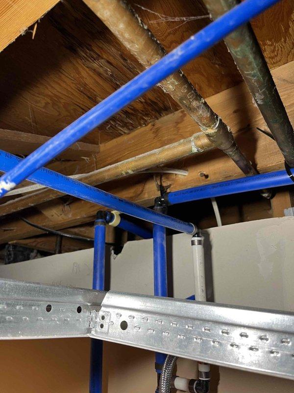 Completed full home repipe, replacing all existing polybutylene piping with PEX piping throughout the structure. New blue PEX water supply lines were installed and secured to floor joists using proper metal clips and hangers, ensuring code-compliant spacing and support. System was pressure tested using calibrated gauge to verify integrity of all connections and confirm zero leaks at operating pressure.