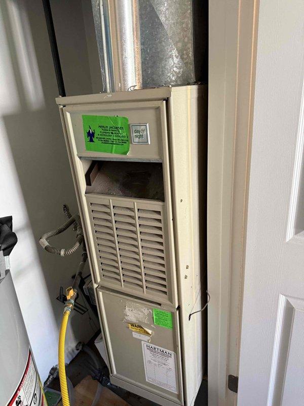 Conducted HVAC system evaluation for residential property in preparation for home sale after inspector identified aging equipment. Assessed existing 20+ year old forced-air furnace unit located in utility closet alongside water heater, documented current system configuration including ductwork and gas line connections. Provided comprehensive replacement estimate for new HVAC system with installation timeline scheduled before winter season.