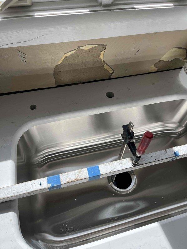 Responded to kitchen sink plumbing issue where shut-off valves failed to stop water flow. Inspected under-sink plumbing assembly including P-trap configuration, chrome angle stop valves, and supply line connections. Assessed malfunctioning shut-off valves and replaced defective valve mechanisms to restore proper water control. Verified all connections for leaks, confirmed both hot and cold water shut-off valves operate correctly, and tested system functionality to ensure complete water shutoff capability.