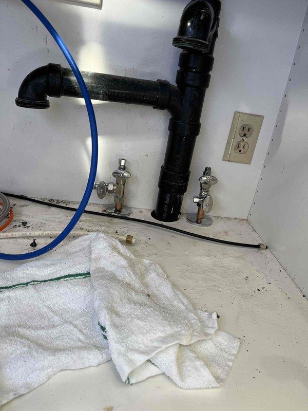 Responded to kitchen sink plumbing issue where shut-off valves failed to stop water flow. Inspected under-sink plumbing assembly including P-trap configuration, chrome angle stop valves, and supply line connections. Assessed malfunctioning shut-off valves and replaced defective valve mechanisms to restore proper water control. Verified all connections for leaks, confirmed both hot and cold water shut-off valves operate correctly, and tested system functionality to ensure complete water shutoff capability.