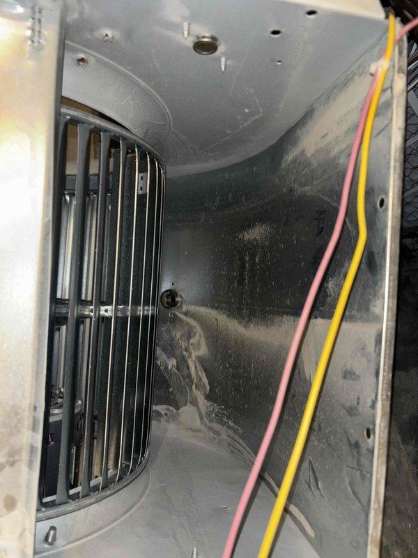 Completed Green Shield cooling maintenance on 12-year-old HVAC system with furnace located in basement and AC unit on north side of house. Removed and cleaned blower wheels, which showed significant dust and debris accumulation typical of equipment requiring scheduled maintenance. Inspected interior compartment, electrical connections, and ductwork; verified proper operation of all components following reassembly.