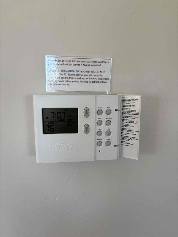 Completed HVAC Cool 5-9 maintenance inspection at condo property with outdoor condensing unit and basement furnace installation. Inspected existing Lennox programmable thermostat, documented current wiring configuration showing standard color-coded connections (red, yellow, green, blue) at terminal blocks, and verified thermostat operation displaying 76°F at time of service. Provided WiFi-capable thermostat for potential upgrade consideration at rental property.