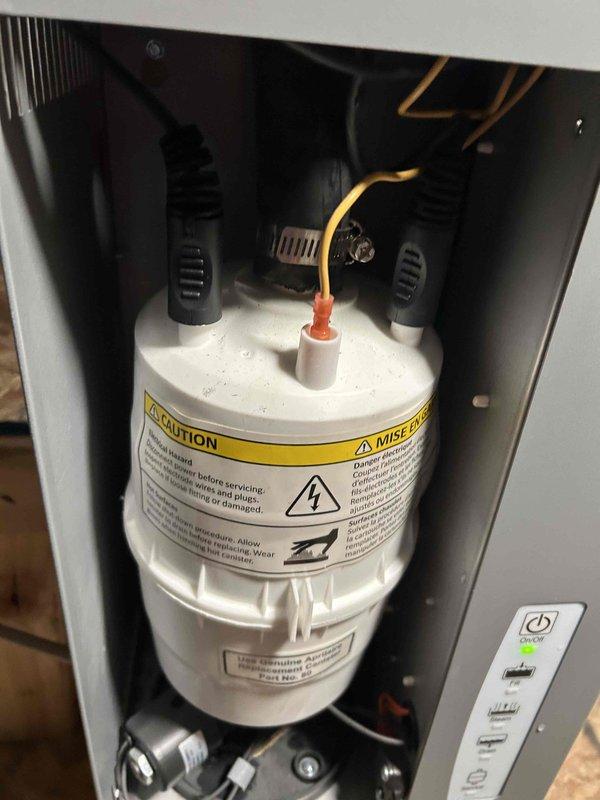 Completed installation of outdoor temperature sensor for humidifier system integration. Sensor was properly wired and configured to communicate with existing whole-home humidification equipment, ensuring accurate humidity control based on outdoor ambient temperature readings. Documentation photographs of equipment serial numbers were captured for service records.