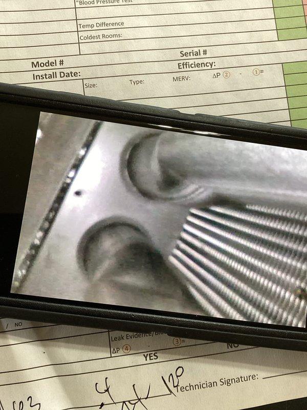 Completed comprehensive furnace maintenance inspection addressing concerns about previous technician notes regarding potential heat exchanger issues and gasket condition. Performed thorough visual examination of heat exchanger for scorching, cracks, or deterioration, inspected all gaskets and seals for leaks, and evaluated evaporator coil assembly and refrigerant lines as documented in photos. All components were assessed for safety and operational integrity, with particular attention to areas previously flagged for monitoring.