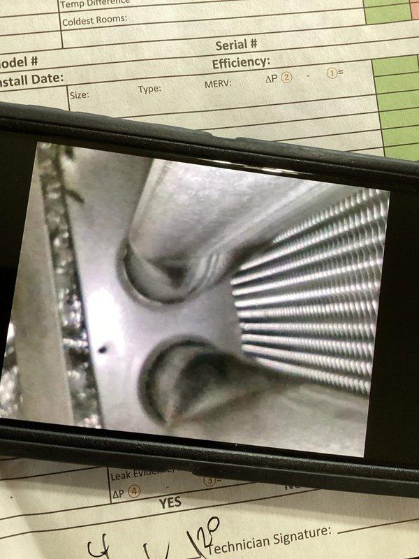 Completed comprehensive furnace maintenance inspection addressing concerns about previous technician notes regarding potential heat exchanger issues and gasket condition. Performed thorough visual examination of heat exchanger for scorching, cracks, or deterioration, inspected all gaskets and seals for leaks, and evaluated evaporator coil assembly and refrigerant lines as documented in photos. All components were assessed for safety and operational integrity, with particular attention to areas previously flagged for monitoring.