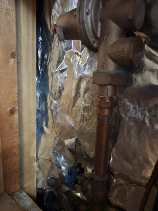 Responded to a malfunctioning 6+ year old gas tank water heater in the basement northwest corner that was providing minimal hot water and actively leaking from underneath the unit. Performed diagnostic inspection of the water heater system, tested pressure levels using calibration gauge, and assessed the copper supply and discharge plumbing connections with shutoff valves. Documented the condition of the failed water heater unit and associated plumbing infrastructure for replacement recommendation.