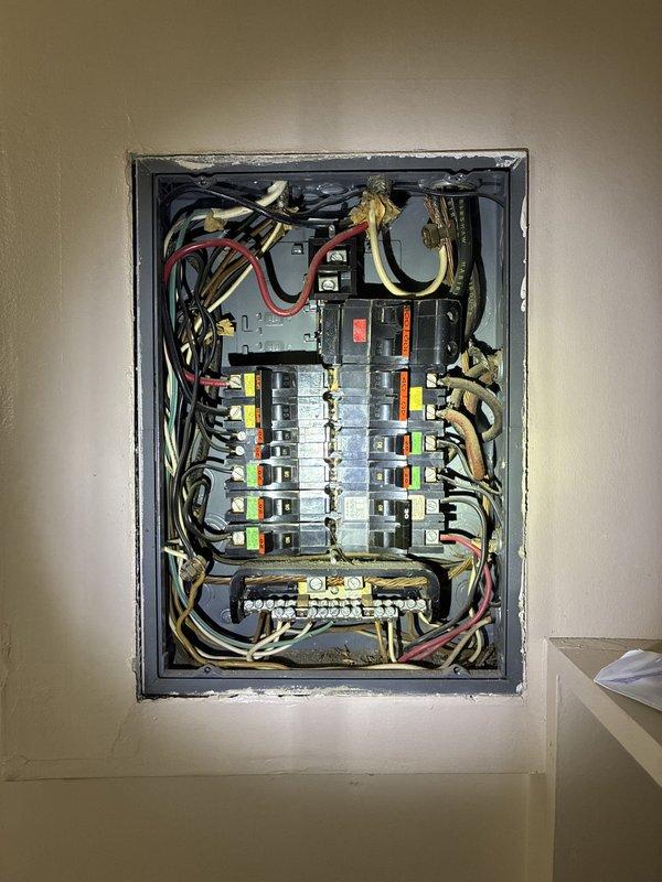 Conducted site evaluation for electrical service upgrade from existing configuration to 200 amp main service with 100 amp subpanel replacement. Inspected current exterior meter base, service entrance conduit, and main distribution panel to assess existing infrastructure and determine scope of work required. Documented current electrical system configuration including panel interior showing multiple circuit breakers, wire routing, and bus bar connections. Photographed exterior service equipment mounted on residential foundation wall and interior panel components to provide comprehensive visual documentation for estimate preparation. Identified necessary materials and labor requirements for complete service upgrade installation.