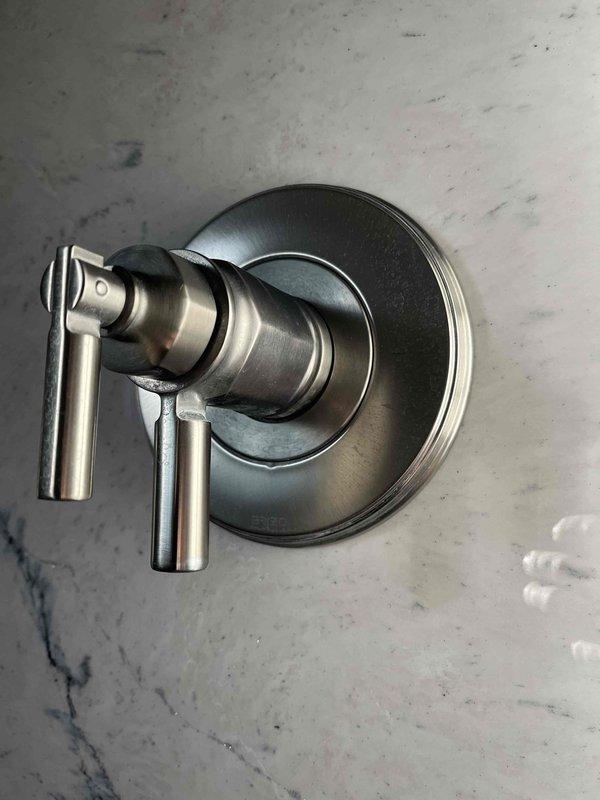 Responded to shower fixture delivering only hot water with no temperature adjustment capability. Diagnosed faulty cartridge in Delta shower mixing valve preventing proper hot and cold water blending. Disassembled valve assembly to identify correct replacement cartridge part number and verified warranty coverage through manufacturer documentation.