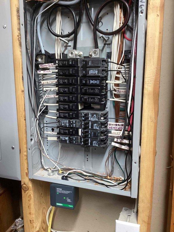 Installed whole-home surge protector at main electrical panel. Device was mounted and wired to panel bus bar, with connections verified and tested for proper operation. All circuit breakers were inspected during installation, panel labeling was reviewed, and system was energized with green indicator light confirming active surge protection.