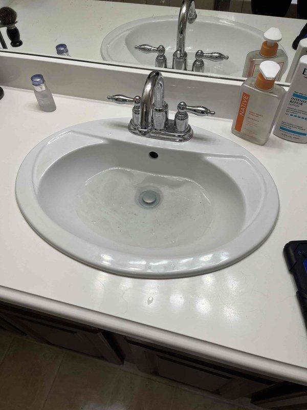 Responded to master bathroom sink draining slowly due to clog in the drain line. Upon arrival, confirmed no chemical drain cleaners had been used in the last 24 hours. Performed mechanical snaking of the sink drain to clear the obstruction and restore proper drainage flow. Tested the fixture after clearing to verify water drains freely without backup or slow drainage issues.