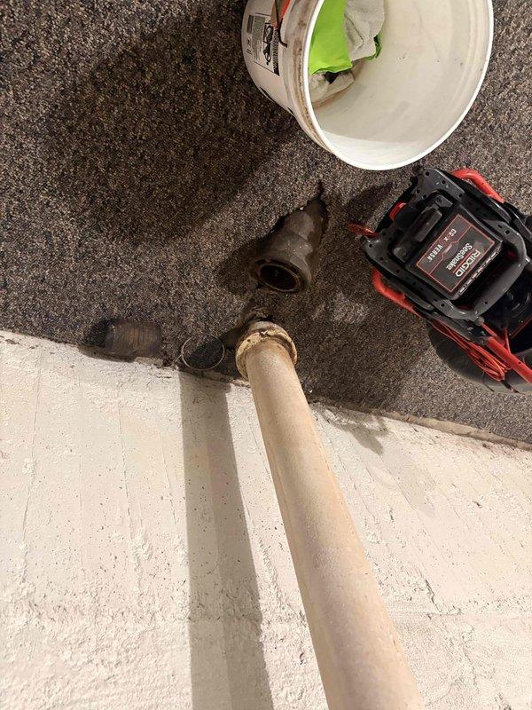 Responded to a whole-home sewer backup with active flooding affecting all plumbing fixtures. Upon arrival, discovered a main line blockage between the house and street, complicated by a previously installed inflatable pipe balloon that had deflated and been displaced by water pressure. Accessed the cleanout point where corroded metal fittings and aged PVC connections were present in the basement utility area. Removed the failed balloon obstruction from the access point and cleared the main sewer line blockage to restore full drainage function to all fixtures throughout the residence.