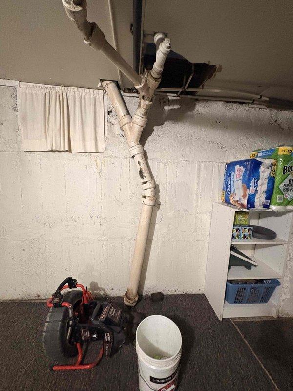 Responded to a whole-home sewer backup with active flooding affecting all plumbing fixtures. Upon arrival, discovered a main line blockage between the house and street, complicated by a previously installed inflatable pipe balloon that had deflated and been displaced by water pressure. Accessed the cleanout point where corroded metal fittings and aged PVC connections were present in the basement utility area. Removed the failed balloon obstruction from the access point and cleared the main sewer line blockage to restore full drainage function to all fixtures throughout the residence.