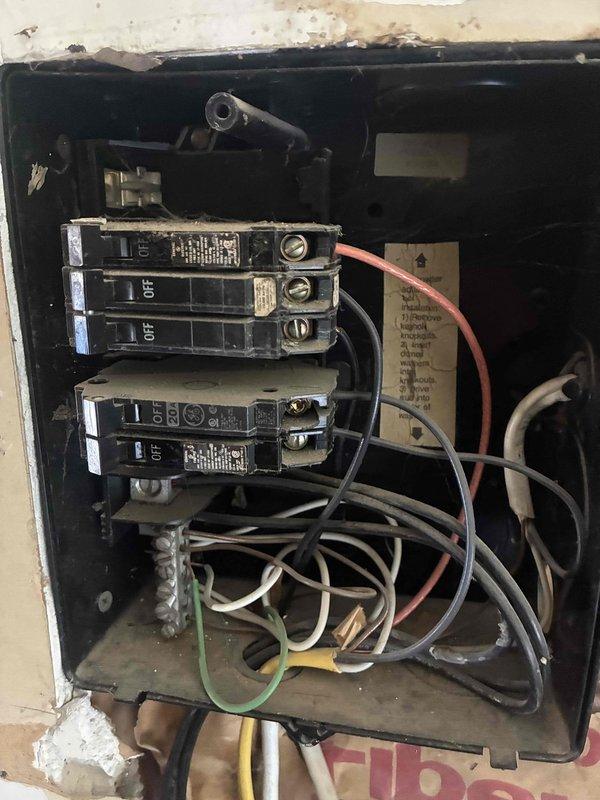 Performed comprehensive electrical inspection throughout the residence in response to reports of sparking outlets and safety concerns. Identified critical code violation where the air conditioning unit was improperly wired into the furnace circuit on an undersized 20-amp breaker instead of the required 25-amp dedicated circuit, causing the breaker to fail and arc. Found no disconnect installed for the AC unit as required by electrical code. Shut off power to the compromised circuit to prevent fire hazard. Inspected and documented electrical panel conditions, noting disorganized wiring, aging components, and multiple code deficiencies. Evaluated outlets and switches in bedrooms, living room, and kitchen as reported. Provided recommendations for installing proper dedicated AC circuit with appropriate amperage breaker, adding required disconnect, and addressing electrical safety concerns throughout the home.