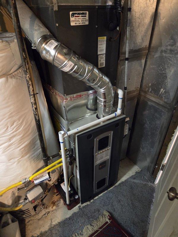 Completed full furnace replacement in basement, installing 80,000 BTU 2-stage unit model S8X2B080M4 to replace existing system that had a cracked heat exchanger. Replaced standard pressure switch with high-altitude pressure switch for proper operation. Upgraded thermostat to T6 model with 5-wire connection to accommodate 2-stage heating functionality. Connected unit to existing 6-inch main flue stack. Provided 10 additional 20x20x1 filters for ongoing maintenance. Removed old furnace from premises for proper disposal, tagged with appropriate job information for tracking purposes.