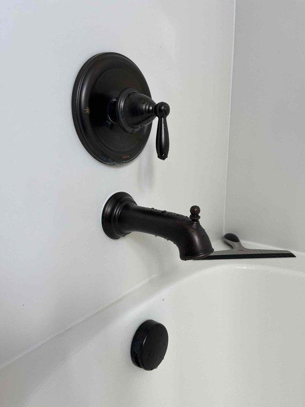 Responded to service call addressing three plumbing issues in residential property. Inspected laundry room drain experiencing foul odors, identifying potential trap or venting concerns. Evaluated and repaired leaking outdoor hose bib, replacing worn components including corroded pipe fittings and connections. Diagnosed and resolved screeching noise in second-floor bathroom shower by servicing the tub and shower valve assembly with oil-rubbed bronze finish fixtures. All repairs completed and fixtures tested for proper operation and leak-free performance.
