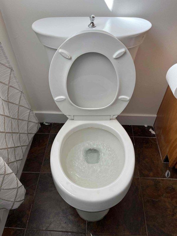 Responded to report of water leaking from toilet in upstairs bathroom. Upon inspection, identified failed wax ring seal at base of toilet causing water seepage. Removed toilet from floor flange, scraped and cleaned old wax ring residue from both flange and toilet base. Installed new wax ring seal and properly reset toilet to floor flange, ensuring level placement and proper alignment. Tightened closet bolts to manufacturer specifications and reconnected water supply line. Tested toilet operation through multiple flush cycles to verify proper sealing and confirm no water leakage at base. Fixture is now operating correctly with no active leaks detected.