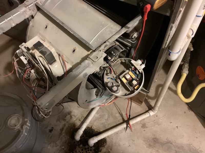 Responded to service call for 10-year-old air conditioning system experiencing insufficient airflow through vents and evaporator coil freezing on one of two units. Upon arrival, accessed basement-located HVAC equipment and performed comprehensive Cool 10+ preventive maintenance inspection. Examined blower motor assembly and electrical connections, inspecting for reported electrical issues including potential shorts or fuse problems. Evaluated evaporator coil condition and checked for airflow restrictions that could contribute to freezing. Verified blower motor operation and amperage draw. Inspected all wire connections to motor assembly and control board. Checked air filter condition and ductwork for obstructions affecting system airflow. Assessed refrigerant levels and system pressures to determine cause of coil freezing. Cleaned accessible components and verified proper system operation. Documented equipment condition with photographs showing internal furnace components, blower motor