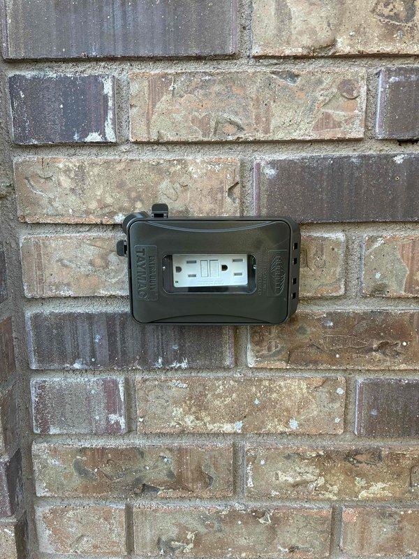 Completed full electrical service including installation and testing of GFCI outlets in two locations. Installed weatherproof GFCI receptacle with cover on exterior brick wall and replaced kitchen backsplash outlet with GFCI protection near cooking appliance to meet current safety code requirements.