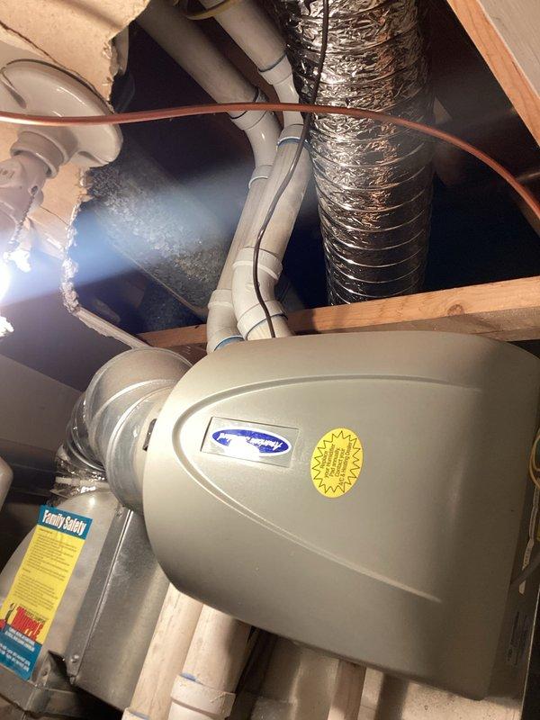 Performed diagnostic evaluation on a 2009 Trane furnace system at a rental property initially scheduled for tune-up service. Inspection revealed multiple critical failures including a failed circuit board, defective flame sensor requiring replacement, and heat exchanger exhibiting signs of overheating damage. Due to the age of the unit (17 years) and extent of necessary repairs, provided replacement estimate to property owner for consideration. Unit located on second level behind laundry room with associated humidifier and ductwork in attic space. Coordinated authorization through property owner prior to proceeding with assessment.