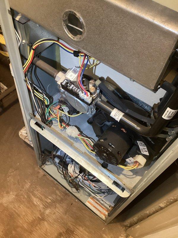 Performed diagnostic evaluation on a 2009 Trane furnace system at a rental property initially scheduled for tune-up service. Inspection revealed multiple critical failures including a failed circuit board, defective flame sensor requiring replacement, and heat exchanger exhibiting signs of overheating damage. Due to the age of the unit (17 years) and extent of necessary repairs, provided replacement estimate to property owner for consideration. Unit located on second level behind laundry room with associated humidifier and ductwork in attic space. Coordinated authorization through property owner prior to proceeding with assessment.